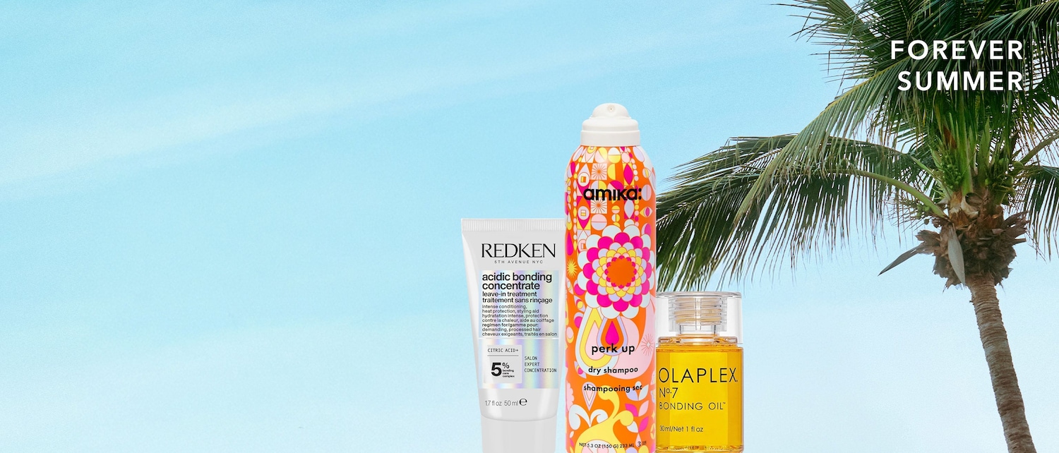 De Redken Acidic Bonding Concentrate leave-in behandeling in een witte tube, Amika Perk Up droogshampoo in een kleurrijke spuitbus en Olaplex No.7 Bonding Oil in een transparant flesje, staan klaar voor een zomerse haarverzorging.